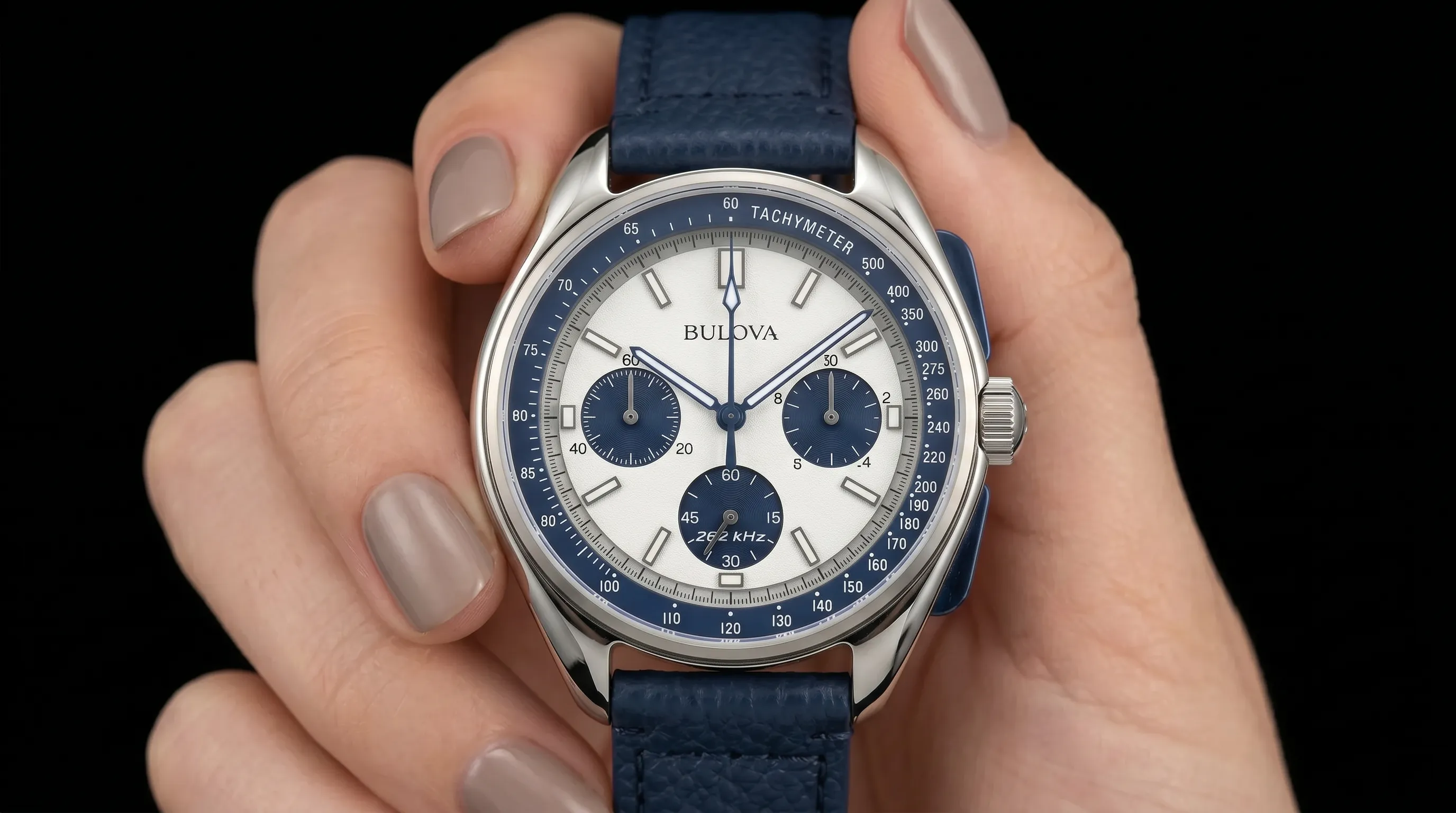 A Bulova chronograph with white dial and blue leather strap
